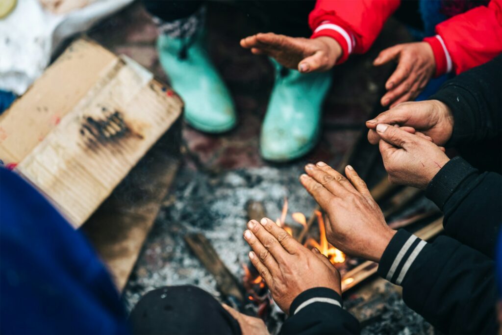 A group of people sitting around a fire