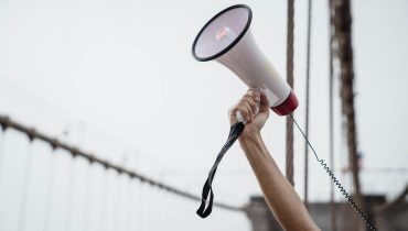 Person Holding White and Black Megaphone